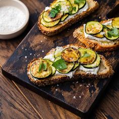 three slices of bread topped with cucumbers and cheese