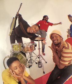 three men are posing for a photo in front of musical instruments and drum sticks,