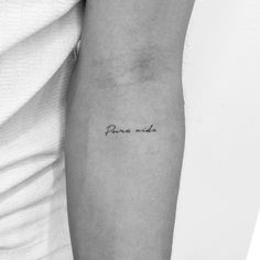 a black and white photo of a woman's arm with the word paris written on it