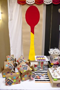 a table topped with boxes filled with cupcakes