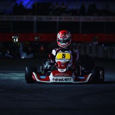 a person driving a go kart at night