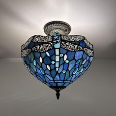 a blue dragonfly light fixture hanging from the ceiling