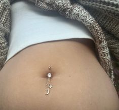 Channel your inner moon goddess with this beautiful gold moon belly ring ✨🌙 Made with clear quartz, gold chain, a star and moon charm. Belly ring base is 14g surgical steel with a cubic zirconia center. 🤍   Total drop length is 2-2.5 inches. >> BUY 3 GET 1 FREE <<  *no coupon code needed. when you purchase 3 belly rings from my shop you'll automatically receive a 4th one for free  SILVER MOON BELLY RING:  https://www.etsy.com/listing/1560417581/crystal-moon-dangle-belly-rings-hippie?click_key=1794e91fbd7cdefab3bef88cc1f7c79c5a7bd158%3A1560417581&click_sum=d3e2de51&ref=shop_home_active_4&frs=1&sca=1 CUSTOM BELLY RINGS:  https://www.etsy.com/listing/1436127690/crystal-belly-rings-hippie-belly-button?click_key=b0ba7087a3dd44ac30071855bf58f0b0fce4445c%3A1436127690&click_sum=3886f4aa&ref=shop Rings Moon, Rings Hippie, Belly Button Rings Dangle, Belly Button Jewelry, Dangle Belly Rings, Crystal Moon, Belly Jewelry, Belly Button Ring, Button Ring