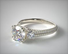 two stone engagement ring with diamond accents on the band and side stones in white gold