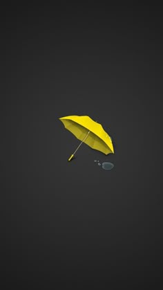 a yellow umbrella is floating in the air