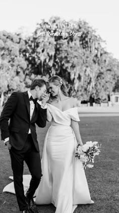 a bride and groom standing in the grass