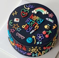 a birthday cake is decorated with colorful icing