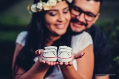 a man and woman holding white shoes in their hands