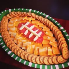 a football shaped cheese platter with crackers