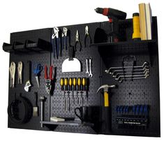 a pegboard with tools hanging on it