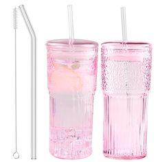 two pink glass cups with straws next to each other