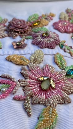 beaded flowers and leaves on a white cloth