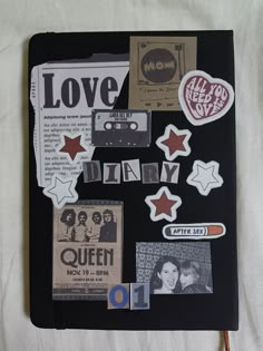 a book with various stickers and pictures on the pages that spell out love diary