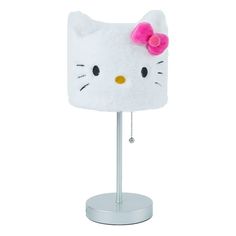 a white hello kitty lamp with a pink bow on it's head