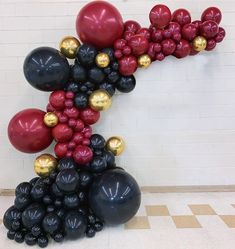 a number made out of balloons in the shape of a letter k on a tiled floor