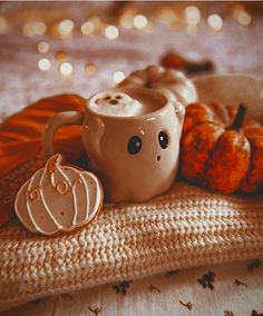 a coffee cup and some pumpkins on a table