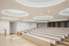 an empty lecture hall with rows of seats