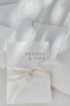 the wedding stationery is laid out on top of each other