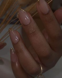 Chicago Nail Artist , danarubylee on Instagram: "One of the best collaborations. Nude, gold, and great nail care. . . . . . #realhotnailshit  #realhotnailshxt   #chicagonails #natrualnails #gelnails #nailcare #aesthetic #goldnails #almondnails #almondshapenails   Chicago nail tech , natural nail care , gel nails , almond nails" Natural Gel X Nails Almond, Gold Design Almond Nails, Gold Nail Tips French, Natural Looking Acrylic Nails Almond, Cute Short Almond Nails Fall, Clean Fall Nails, Hoco Nails Gold, Nude And Gold Nails Short, Champagne French Tip Nails