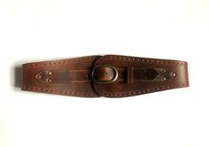 "This beautiful waist belt is made with a gorgeous semi- veg tanned leather. The material chosen is the best quality leather with a 3mm thickness.  It is sturdy, durable and will aged nicely. The belt is designed to fastened at the front. The buckle is 4.5 cm high and 7 cm long and antique brass finished for all colours. The front panel height is about 10cm, the side about 6cm and at the centre back it is about 5.5cm. It does varies tiny bit from size to size to keep the proportion. The sizes work as below. The measurements being taken at the natural waist which refers to the narrowest point between the bottom of the rib cage and the pelvis, about 1\" above the belly button. When you measure yourself make sure you allow breathing allowance. Choose your size: XS              63.5 - 68.5 cm Leather Bag Design, Cincher Belt, Measure Yourself, Belt Belt, Veg Tan Leather, Wide Belt, Rib Cage, Bag Design, Belly Button