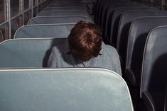 the back of a man's head sitting on an empty seat