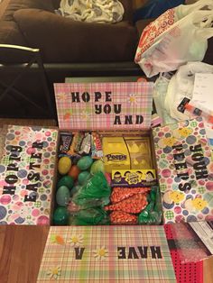 a box filled with lots of candy and candies sitting on top of a table