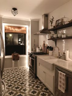 a kitchen with black and white tile flooring