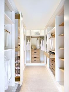 an empty walk in closet with lots of drawers