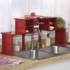 a kitchen sink sitting under a window next to a counter