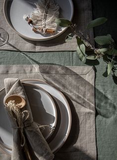 the place setting is set with plates and napkins