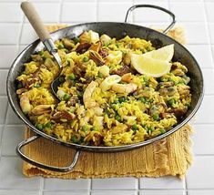 a pan filled with rice and peas on top of a table