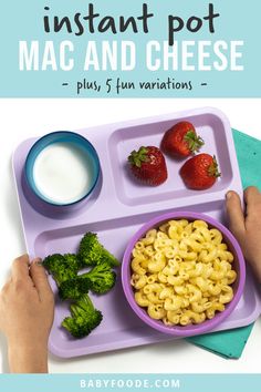 a tray with macaroni and cheese next to strawberries