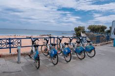 several bicycles parked next to each other near the beach