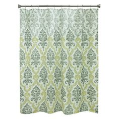 a green and white shower curtain with an ornate pattern