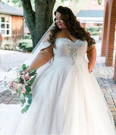 a woman in a wedding dress is walking down the street