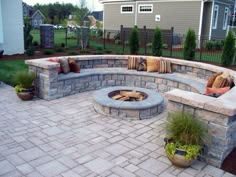 an outdoor fire pit with seating around it