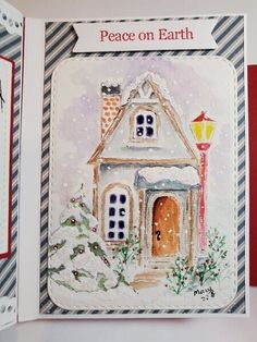 an open christmas card with a house on it