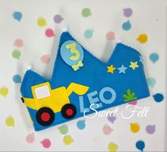 a blue felt crown with a yellow construction truck on it