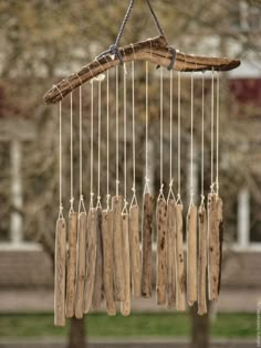 a wind chime made out of driftwood hanging from a tree