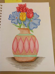 a drawing of flowers in a vase with colored pencils on the paper next to it