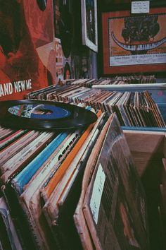 an old record player sitting on top of a pile of records