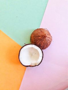 two coconuts are sitting next to each other on a multicolored tablecloth