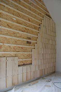 a room that is being built with wood planks on the wall and insulation in place