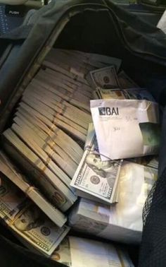 a bag filled with money and sitting on top of a table