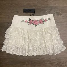 This Mini Skirt Has A Twill Construction, An Embroidered Rose Design On The Front, A Layered Ruffled Lace Skirt, And A Side Zipper Closure. Embroidered Rose, Rose Design, Dolls Kill, Lace Skirt, Side Zipper, Pink White, Mini Skirt, Womens Skirt, Mini Skirts