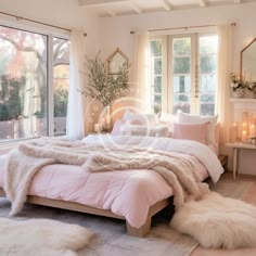 a bedroom with a large bed covered in white blankets and fluffy rugs next to a fireplace