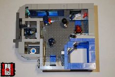 an overhead view of a lego model of a kitchen and living room with blue accents