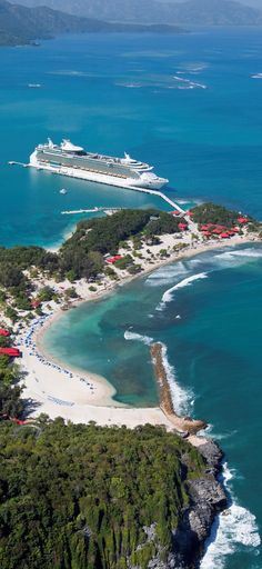 an aerial view of the beach and cruise ship