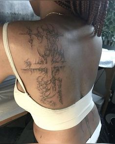 a woman with a cross tattoo on her back