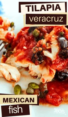 a white plate topped with lasagna covered in sauce and olives next to a fork